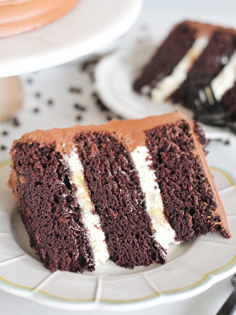 Triple Chocolate Banana Cake: chocolate, chocolate chip banana cake layers with banana cream filling and chocolate buttercream #cakebycourtney #cake #chocolatebananacake #bananacake #bananapudding #chocolatecake #easychocolatecake #moistchocolatecake #bananachocolatecake #bananachocolatebread #banana #chocolate #chocolatebuttercream #magnoliabananapudding