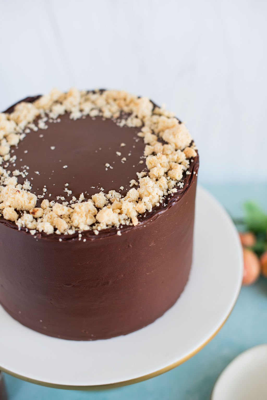 A chocolate cake with shortbread cookie crumbs on it.
