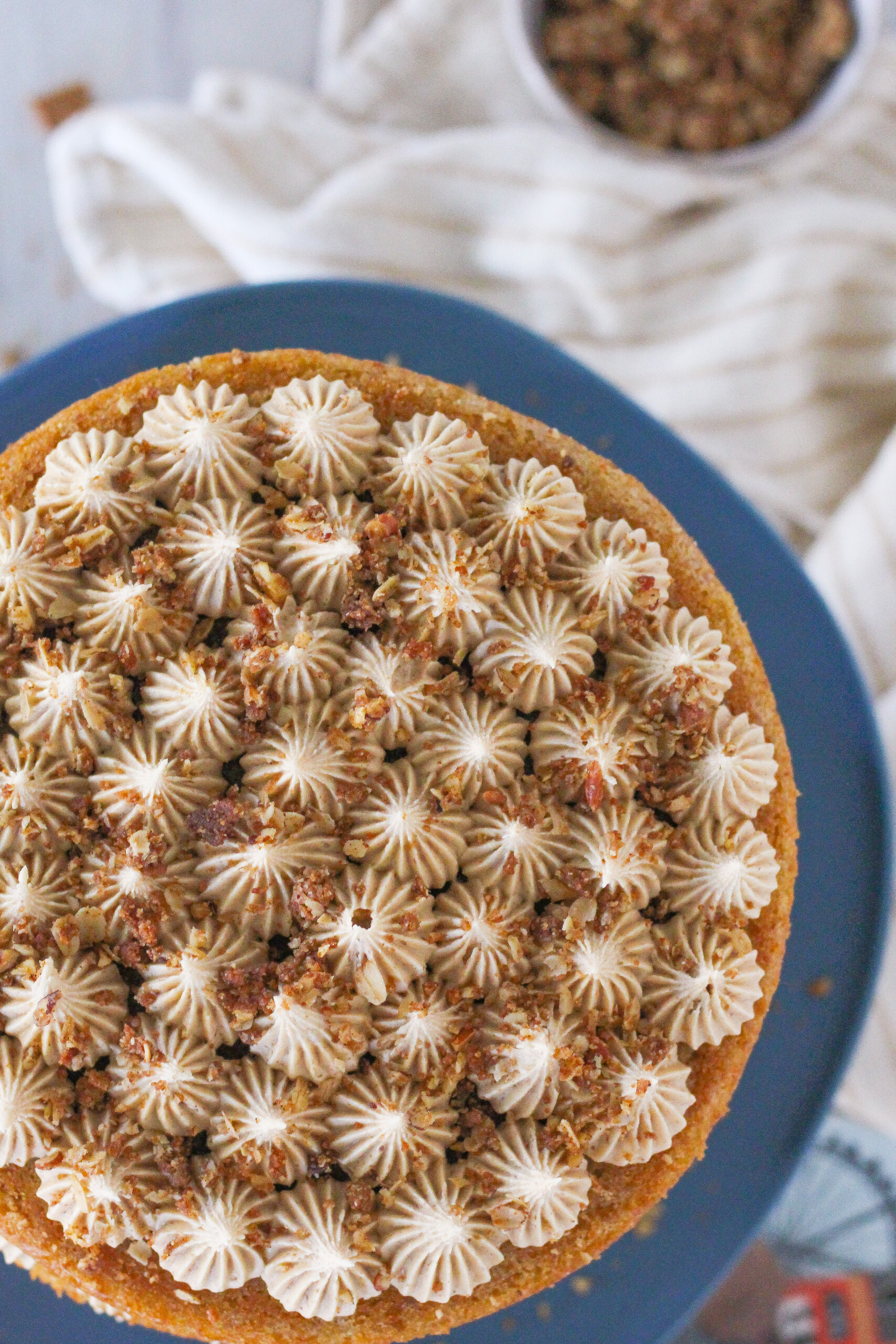 Overhead view of a cake with piping decorations on top.