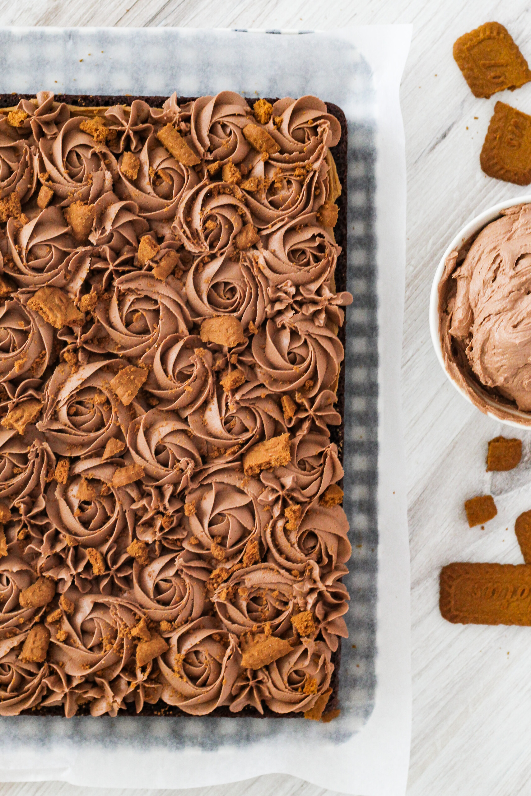 Overhead view of a chocolate cake with chocolate buttercream swirled on top.