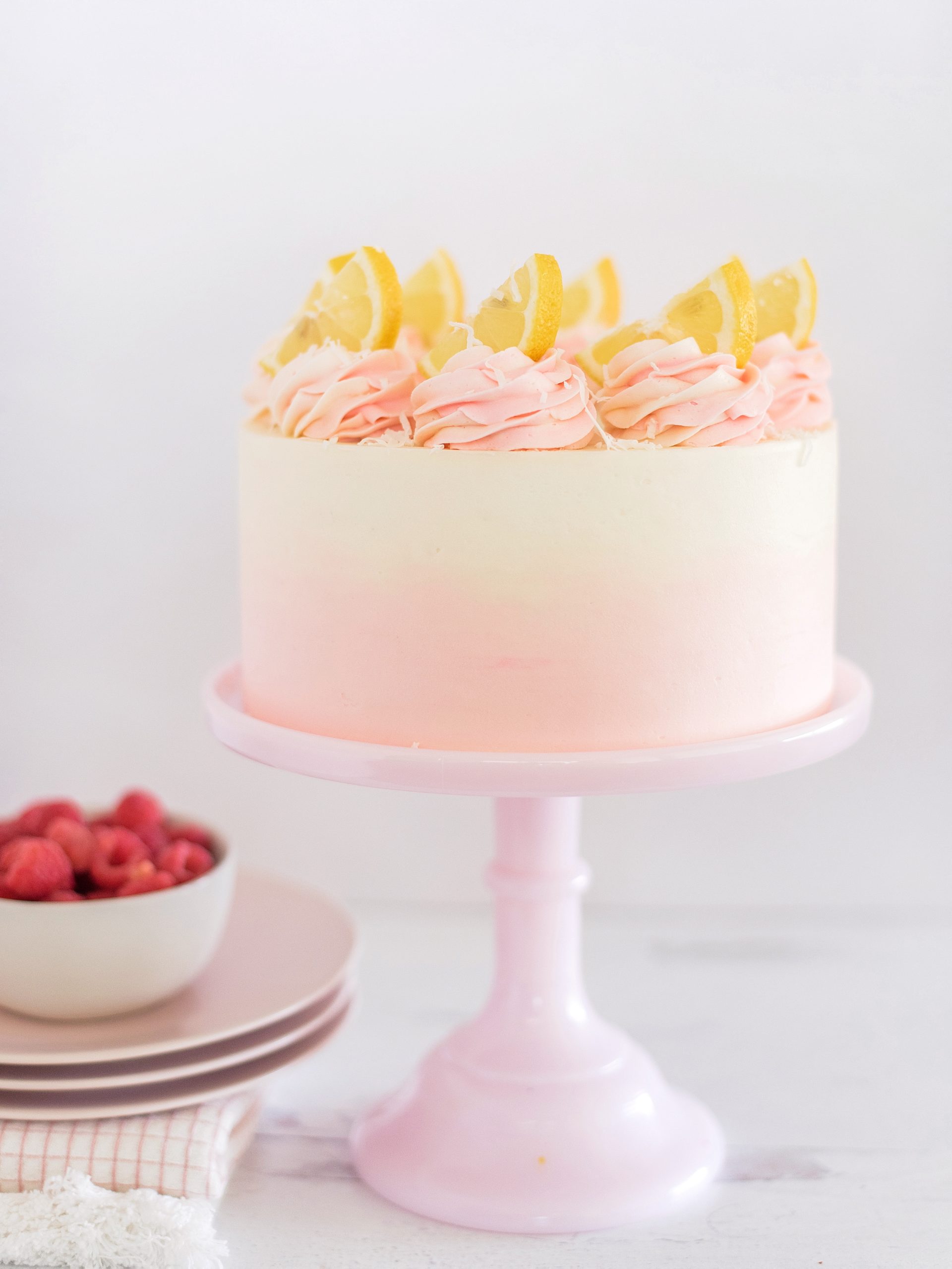 Coconut Lemon Raspberry Cake on a cake stand.