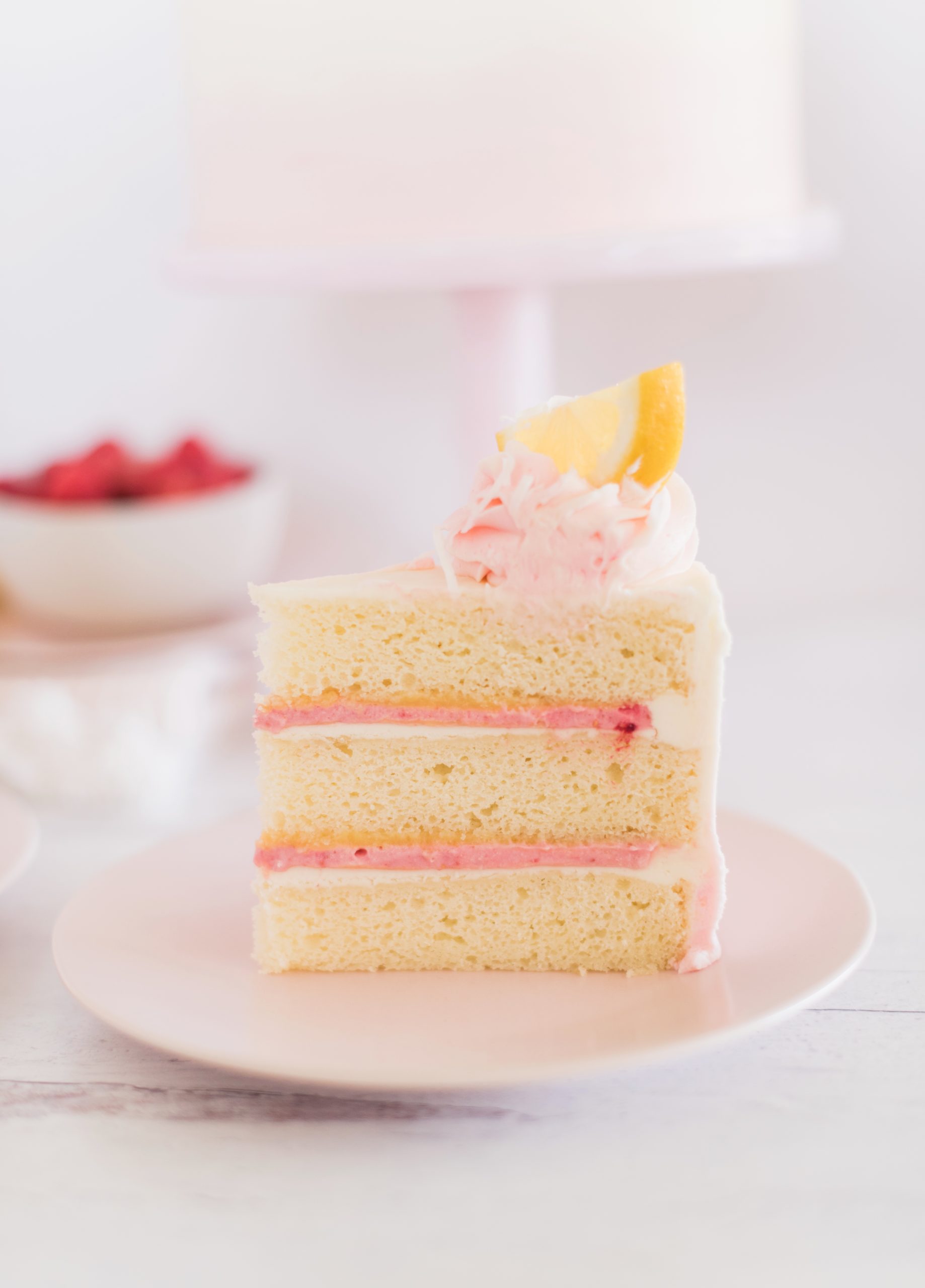Slice of Coconut Lemon Raspberry Cake on a plate.