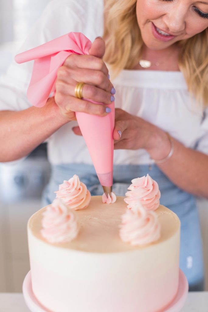 Coconut Lemon Raspberry Cake - coconut cake layers, lemon curd, raspberry cream filling, and coconut buttercream. #cakebycourtney #coconutcake #bestcoconutcake #lemoncurd #raspberrycream #raspberryfilling #coconutbuttercream #summercake #bestsummerdessertrecipes #summercakes #summerdessertrecipes