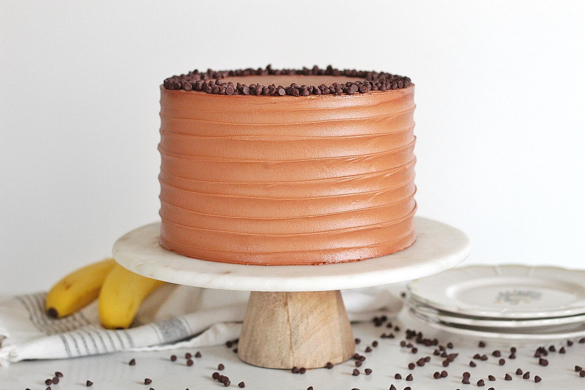 Triple Chocolate Banana Cake: chocolate, chocolate chip banana cake layers with banana cream filling and chocolate buttercream #cakebycourtney #cake #chocolatebananacake #bananacake #bananapudding #chocolatecake #easychocolatecake #moistchocolatecake #bananachocolatecake #bananachocolatebread #banana #chocolate #chocolatebuttercream #magnoliabananapudding