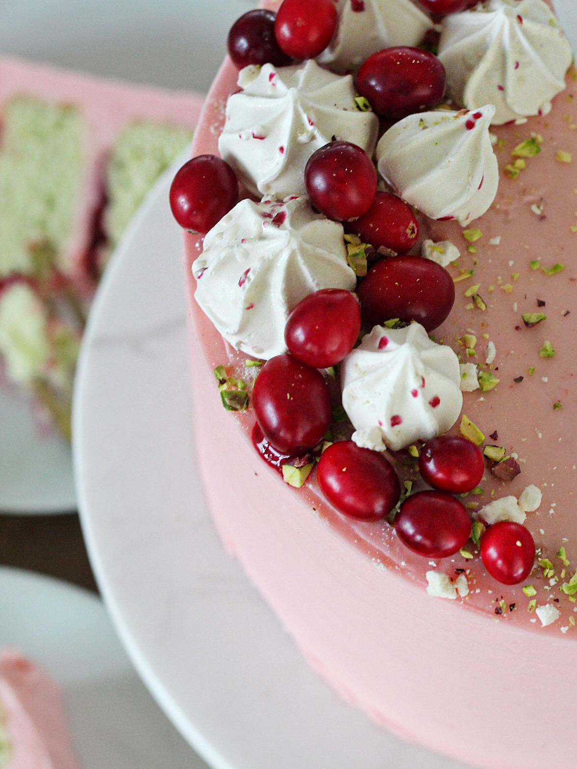 Pistachio Cranberry Cake - Pistachio cake layers with cranberry compote and cranberry buttercream. #cakebycourtney #pistachiocranberrycake #pistachiocake #cranberry #christmascake #easycakerecipe